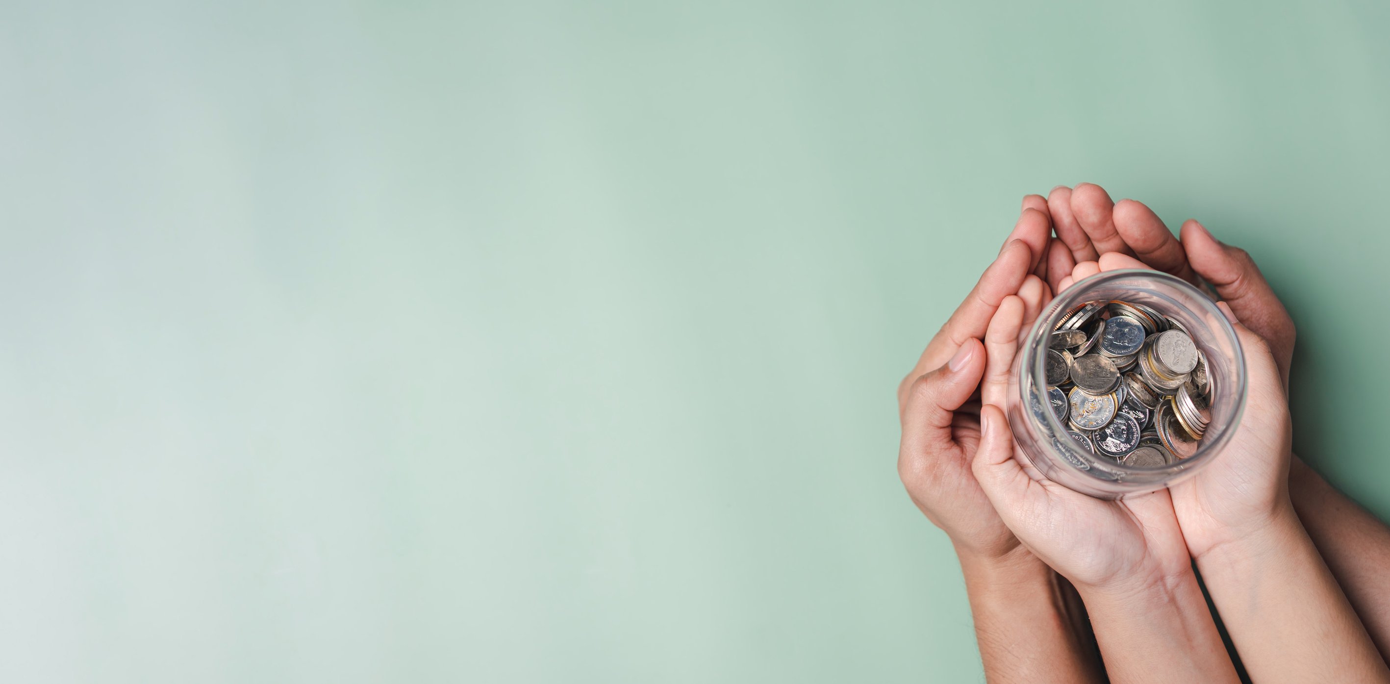 hands of adult and child holding money jar, donation, saving, fu